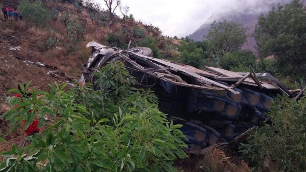 A handout photo made available by Agencia Andina shows the wreckage of a bus that fell into a ravine in Huaccoto, Churcampa province, Peru, 18 September 2023.