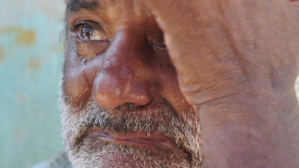 A fisherman cries as he waits for news of his younger brother who has been missing for 11 days