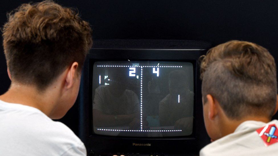 Visitors play the retro game "Pong" at the Video games trade fair Gamescom in Cologne, western Germany, on August 21, 2019.