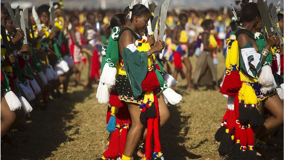 Tens of thousands of maidens, dressed in traditional garb, perform the reed dance for the king during the Umhlanga festival
