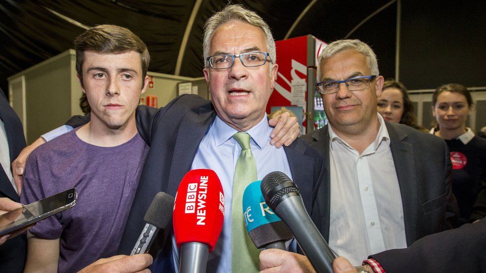 The SDLP's Alex Attwood celebrates with party colleagues after his election in West Belfast