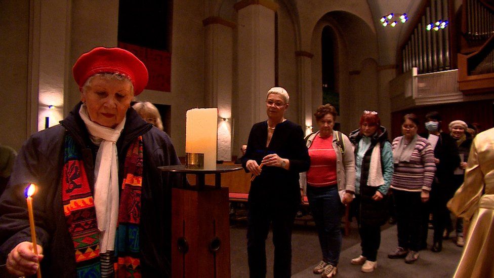 Worshippers queue to light candles in the Marcus church in Berlin
