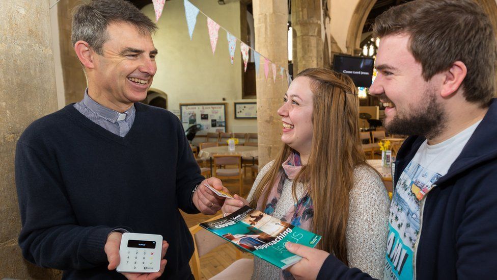 A Church of England vicar accepts a cashless payment