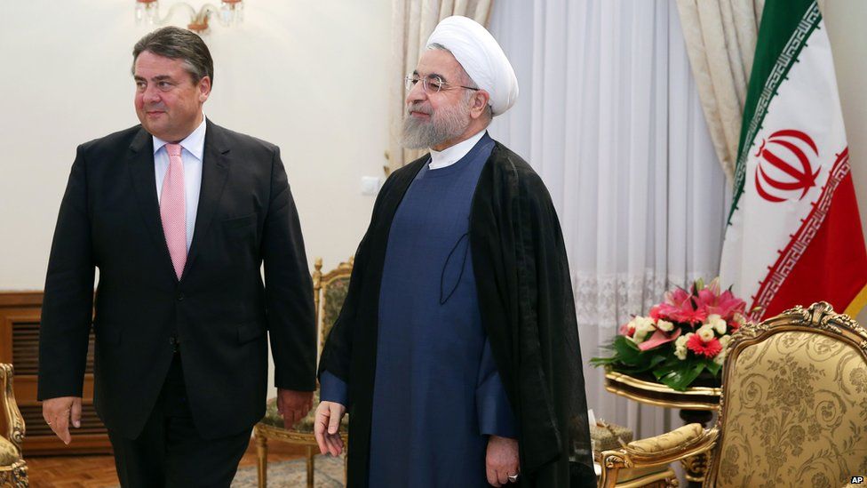 Iran's President Hassan Rouhani, centre, stands with with German Vice Chancellor and Economy Minister Sigmar Gabriel, left