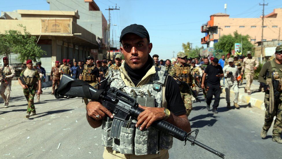 Members of the Hashd al Shaabi patrol in Kirkuk