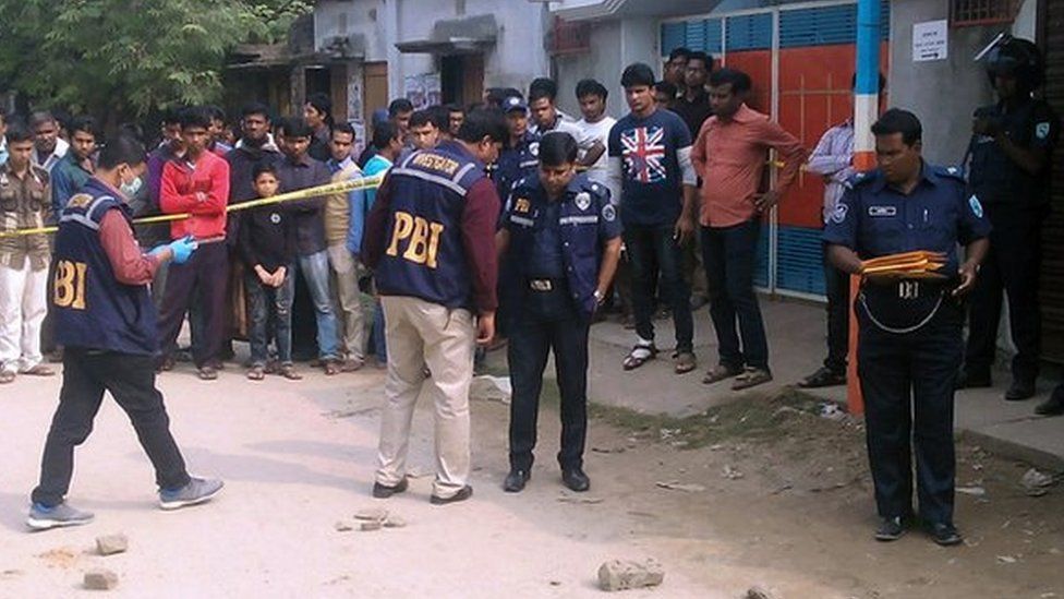 Bangladeshi police officials investigate the scene where an Italian priest was shot in Dinajpur, some 350 kilometres (220 miles) north of Dhaka, on November 18, 2015.