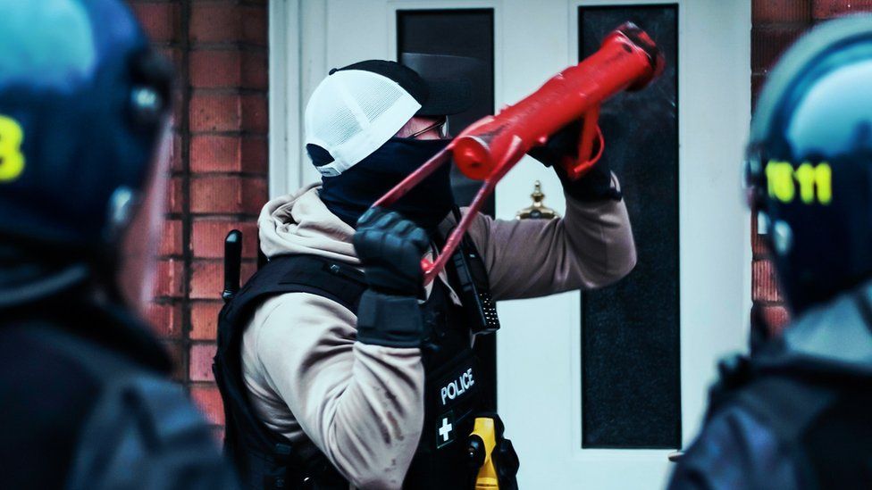 Police using a ram-raid to get into a home