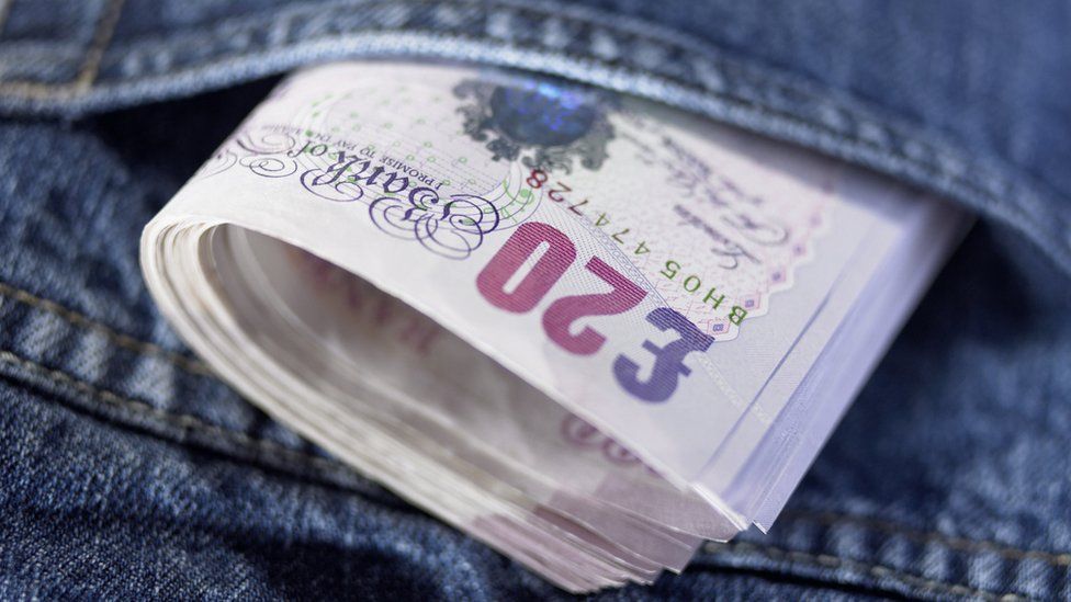 Twenty pound notes in a pocket