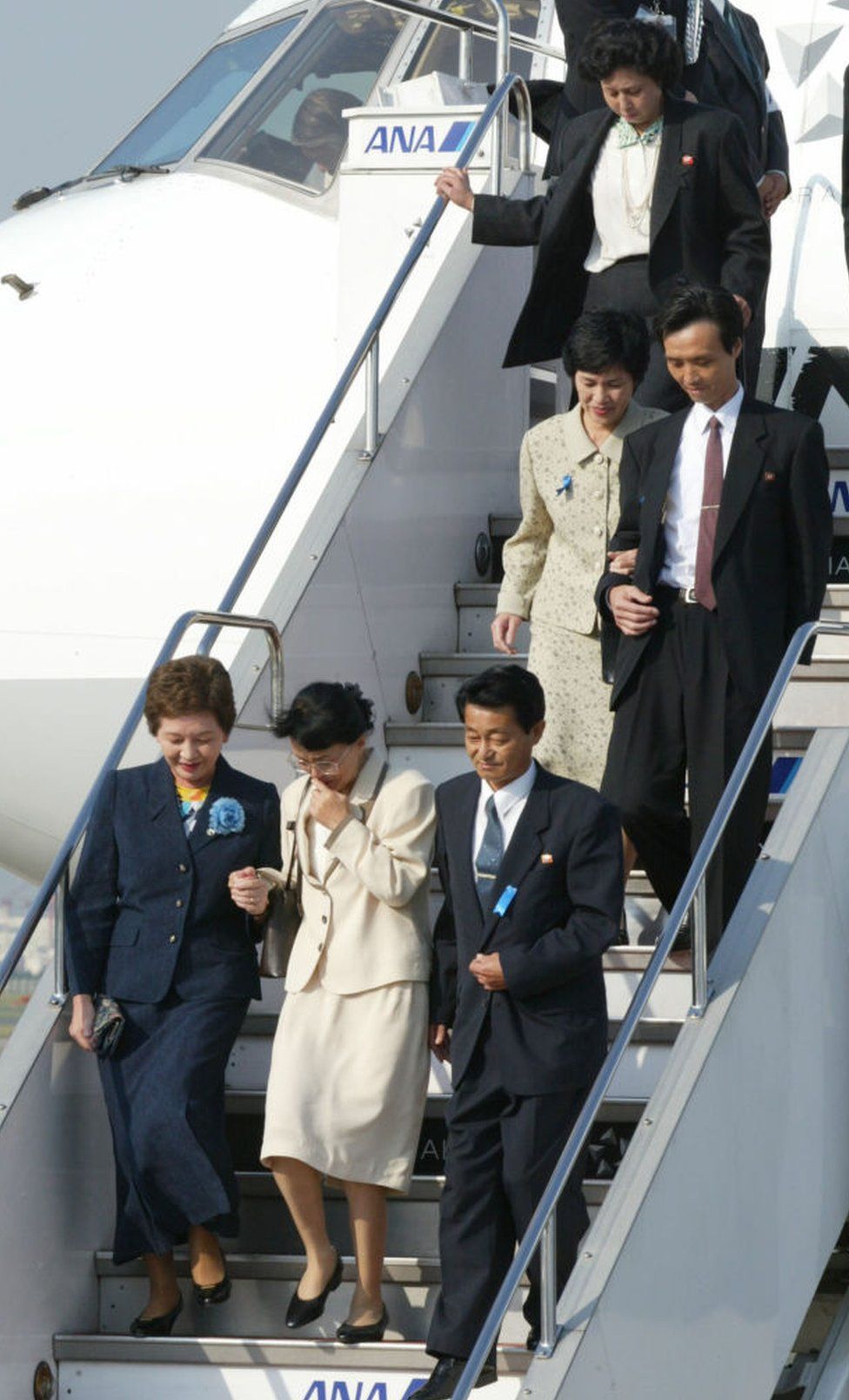 Five Japanese nationals, abducted to North Korea in the 1970s and 80s, arrive at Tokyo's Haneda Airport on October 15, 2002