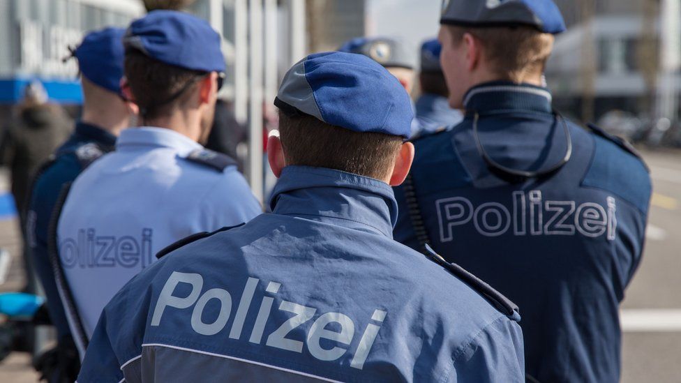 Police officers stand outside in Zurich