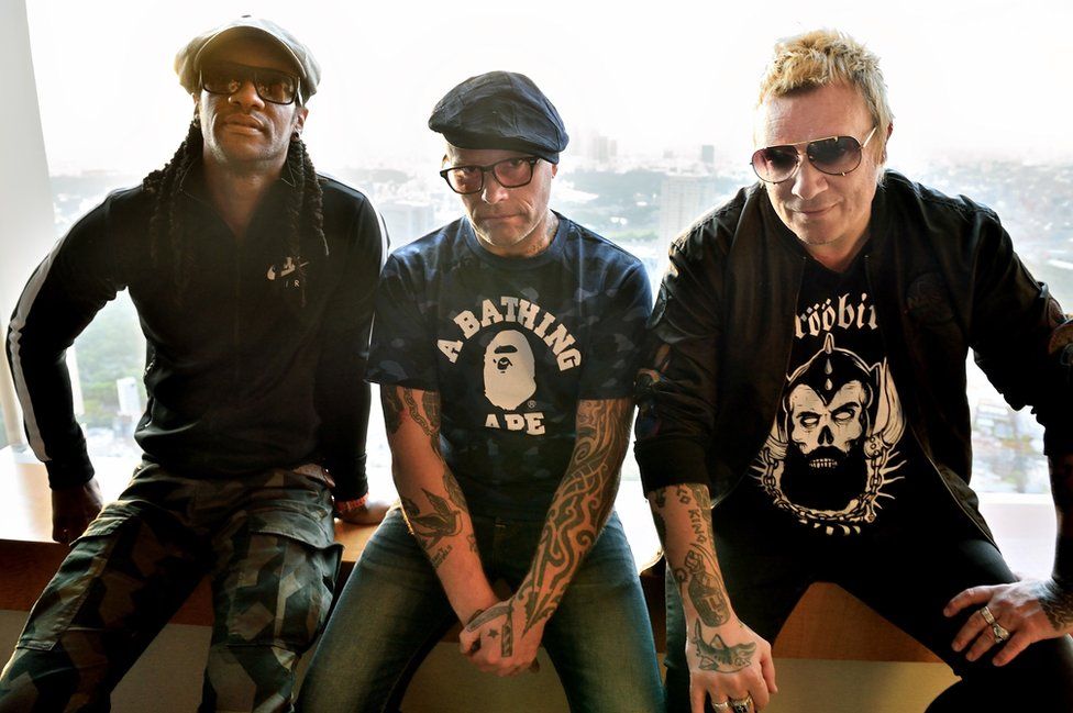 Liam Howlett (R), Keith Flint (C), and Maxim (L) posing prior to an interview in Tokyo, 2015
