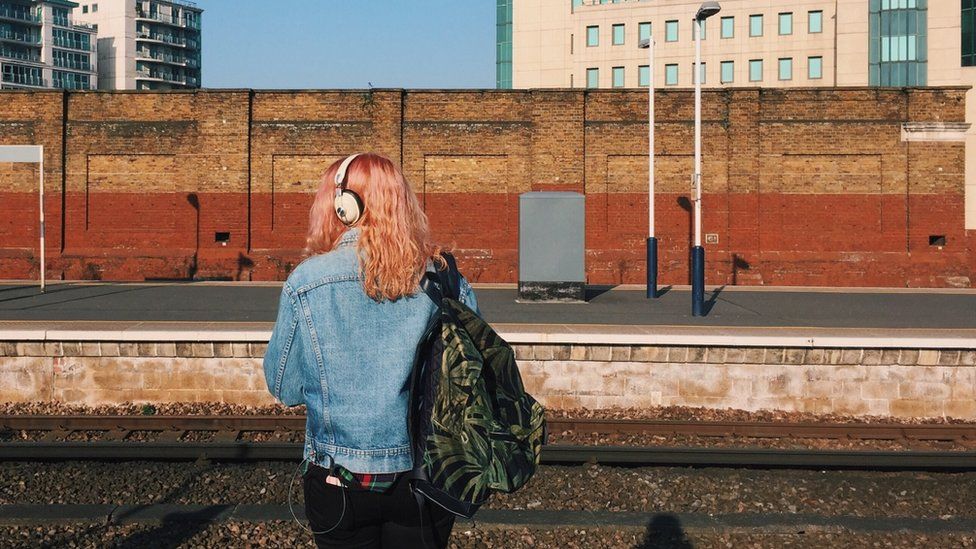 Woman standing at rail station