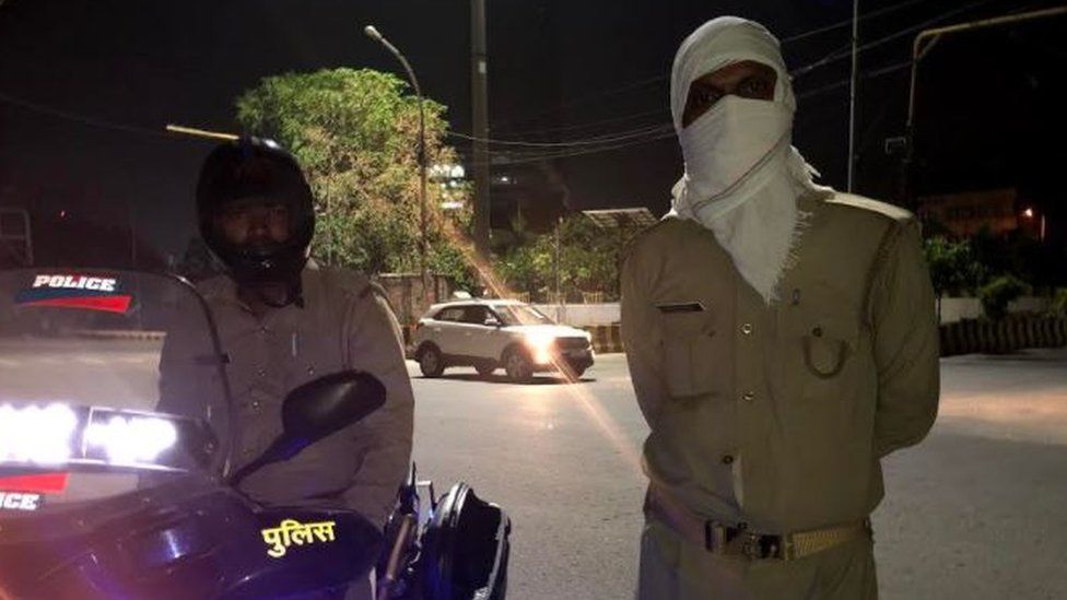 Policemen patrol street stay vigilant in the night as well