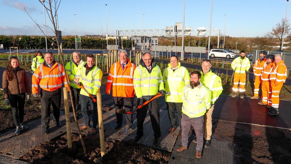 MPs Peter Bone and Tom Pursglove and others at Chowns Mill roundabout tree planting
