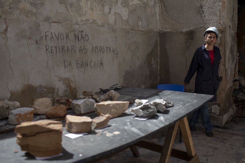 A worker guards artefacts found among the debris inside Brazil's National Museum