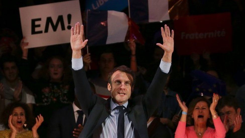 French presidential election candidate Emmanuel Macron waves on stage at the end of a campaign event in central London on February 21
