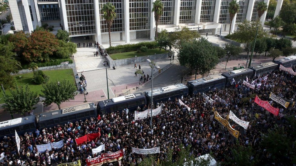 People gather outside the Athens courthouse, as they wait for the verdict of the trial of the ultra-right party Golden Dawn (Chrysi Avgi), in Athens
