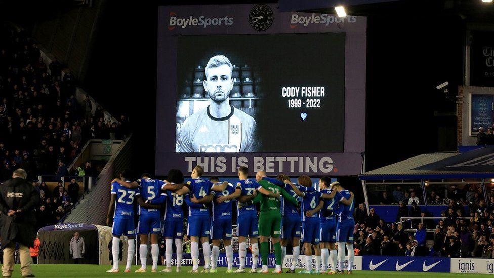 Players of both teams observe a minute's silence for the late Cody Fisher
