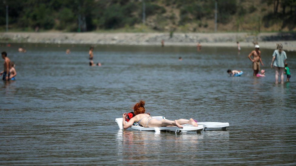 A woman sunbathes in the waters of Lisi lake on a hot summer day in Tbilisi, Georgia, July 10, 2018