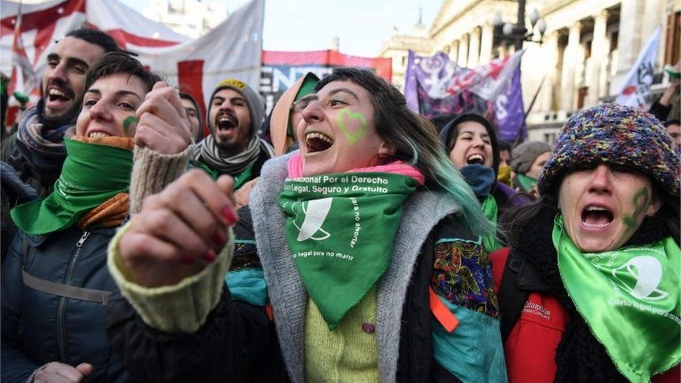Pro-choice activists wait outside the Argentine Congress in Buenos Aires before the approval of a bill to legalise abortion.
