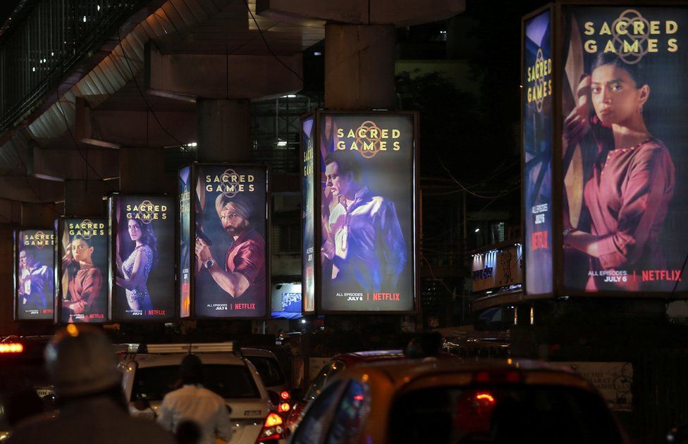 Traffic moves past hoardings of Netflix's television series, Sacred Games, in Mumbai.