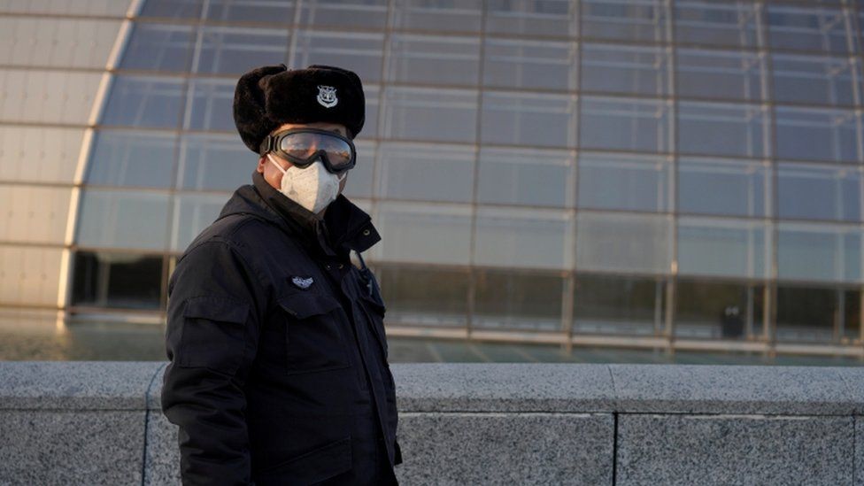 A security guard wears a mask in Beijing