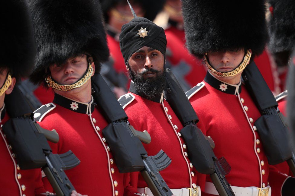 Coldstream Guards soldier Charanpreet Singh Lall marches during Trooping The Colour parade on 9 June