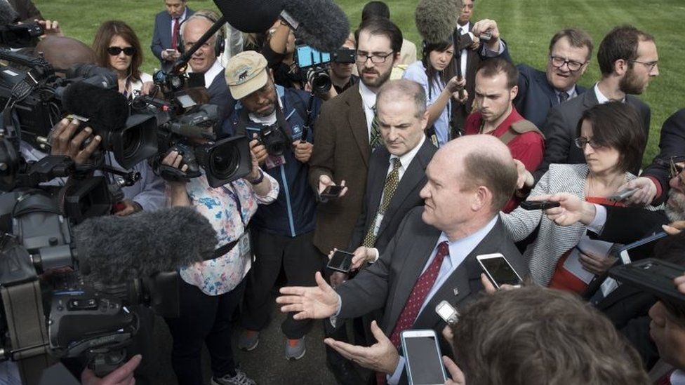 Democratic Senator from Delaware Chris Coons (centre) speaks to journalists following a briefing on North Korea attended by US Senators and Trump administration officials at the Eisenhower Executive Office (26 April 2017)