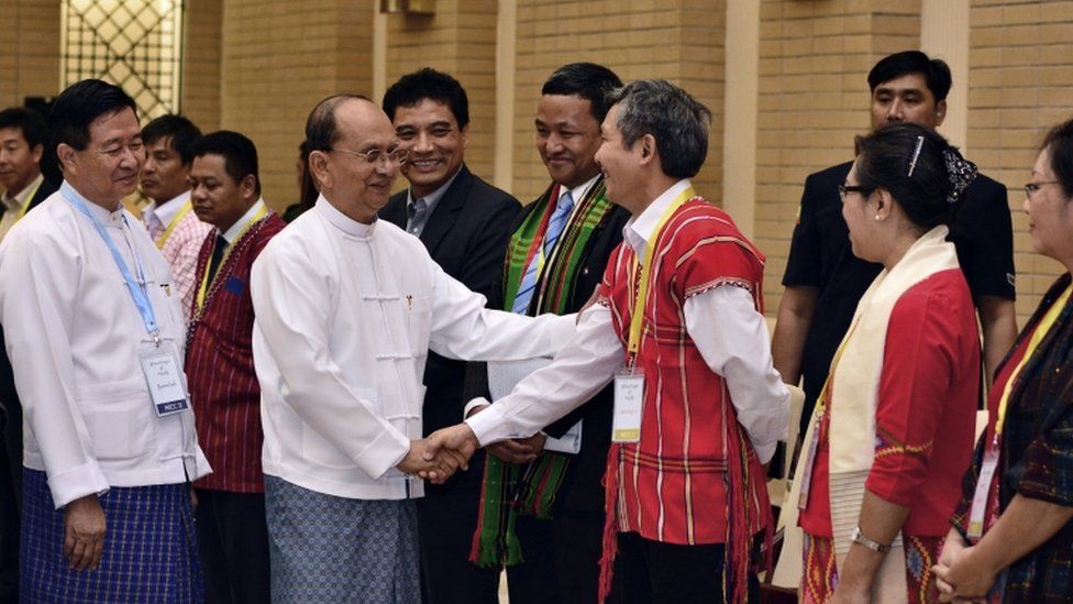 President Thein Sein, centre left in front, shakes hands with a representative of armed ethnic groups during a Nationwide Ceasefire Agreement meeting in Naypyidaw, Myanmar, in September 2015