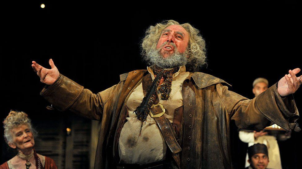 Antony Sher as Sir John Falstaff with company artists in the Royal Shakespeare Company's production of William Shakespeare's Henry IV Part I and II