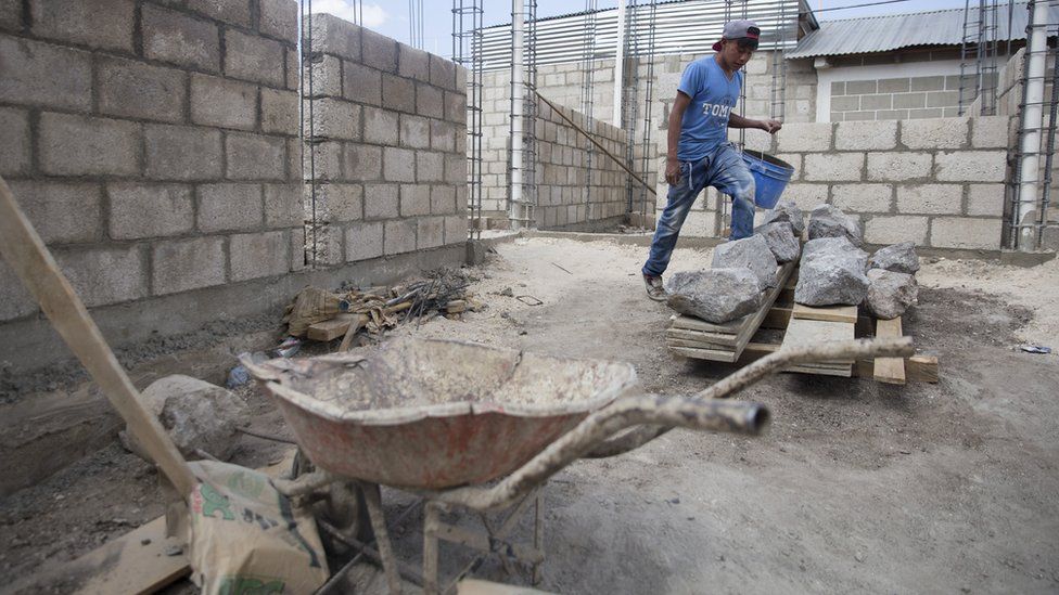 A man works on a construction site in Zunil