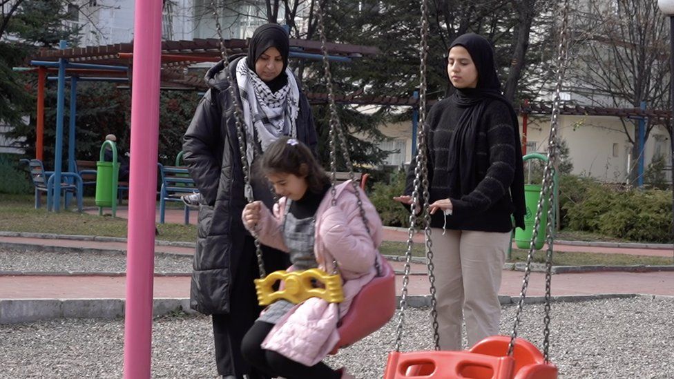 Mona Al-Shorafi with her two daughters at a park in Turkey
