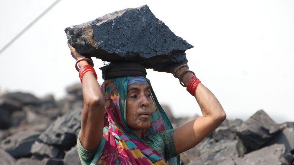 An Indian coal loader works during International Women's Day at Jharia Coalfield in Dhanbad in the eastern Indian state of Jharkhand