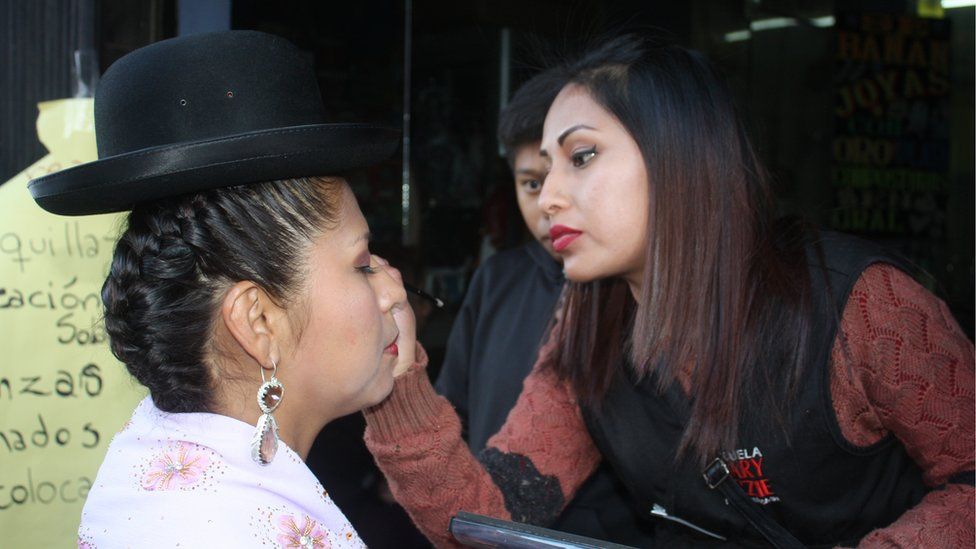 A woman applies make-up to one of the participants in the 2018 event