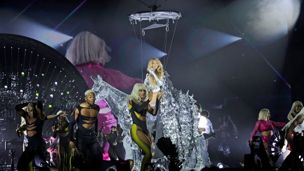 Beyonce gliding through the air on a glitter-encrusted white horse as she performs onstage during the opening night of the “RENAISSANCE WORLD TOUR” in Stockholm, Sweden