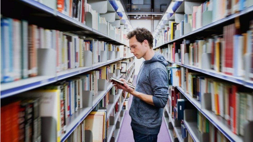 student in library