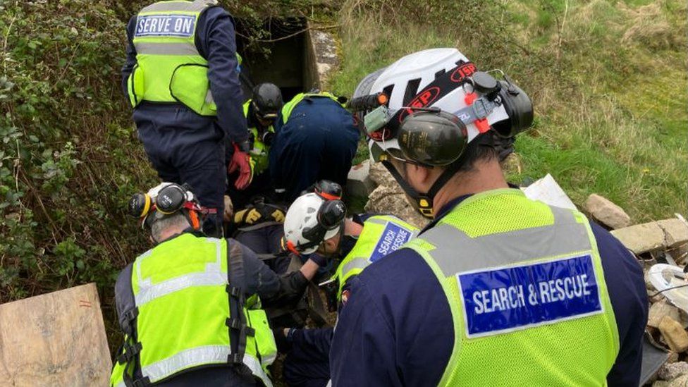 A group of trainee search and rescuers retrieving someone trapped below the ground