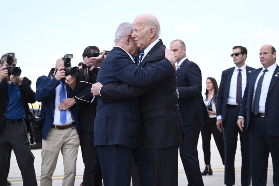 Israel Prime Minister Benjamin Netanyahu (L) hugs US President Joe Biden