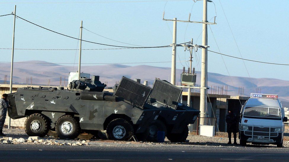 Jordanian police forces deployed on a desert road near Maan, southern Jordan, 16 December 2022