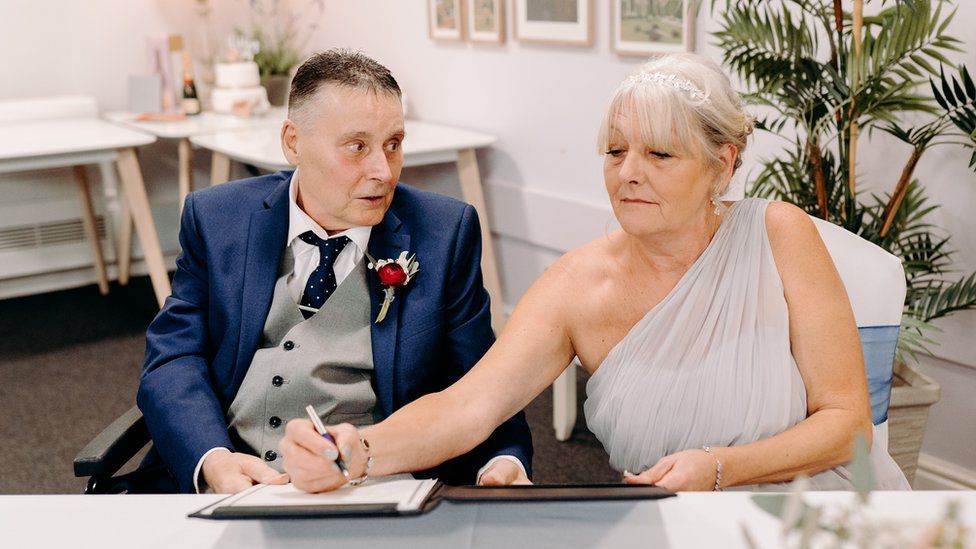 Paul and Hilary Deffley sign their vows at Ashgate Hospice