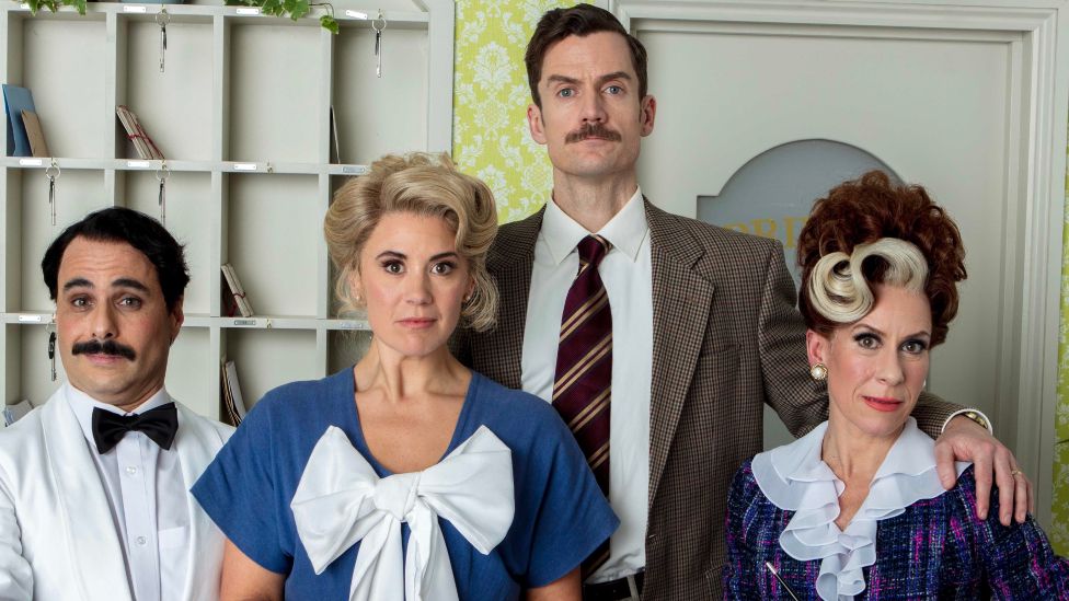 Left to right: Manuel (Hemi Yeroham), Polly (Victoria Fox), Basil (Adam Jackson-Smith) and Sybil (Anna-Jane Casey) in a promotional cast picture for the stage adaptation of Fawlty Towers