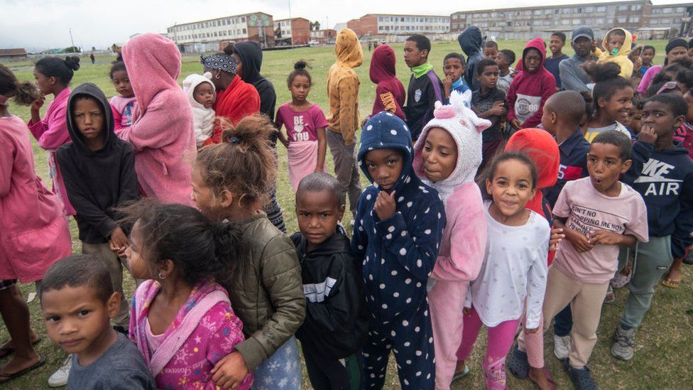 Close to a thousand children received a hot cross bun and a Easter egg on Good Friday in Lavender Hill, Cape Town, South Africa. Mark Nicholson operates a feeding scheme, sports club and an arts and culture centre here.