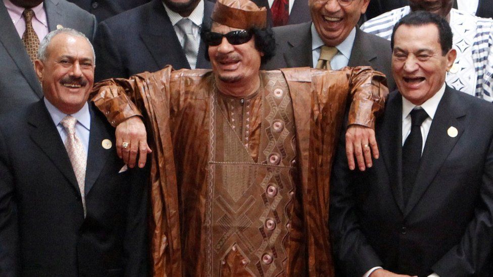 Then Libyan leader Muammar al-Gaddafi (C) leans on the shoulders of then Egyptian President Hosni Mubarak (centre R) and then Yemeni President Ali Abdullah Saleh (centre L) at the second Afro-Arab Summit in Sirte, Libya (10 October 2010)