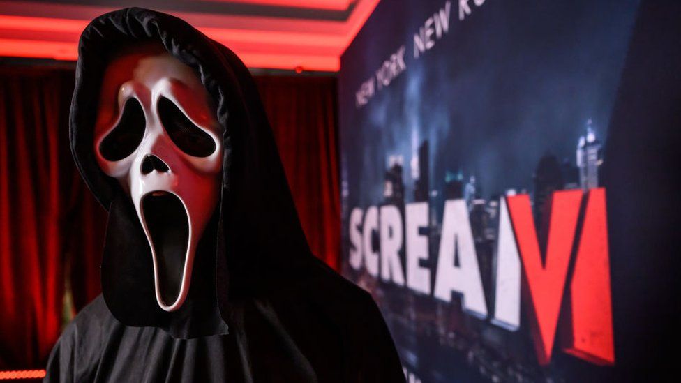 Actor dressed as Ghostface from the Scream film franchise