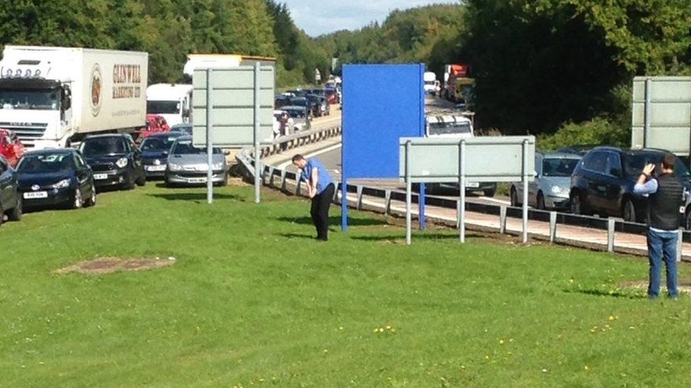 Man practising golf moves on the M3
