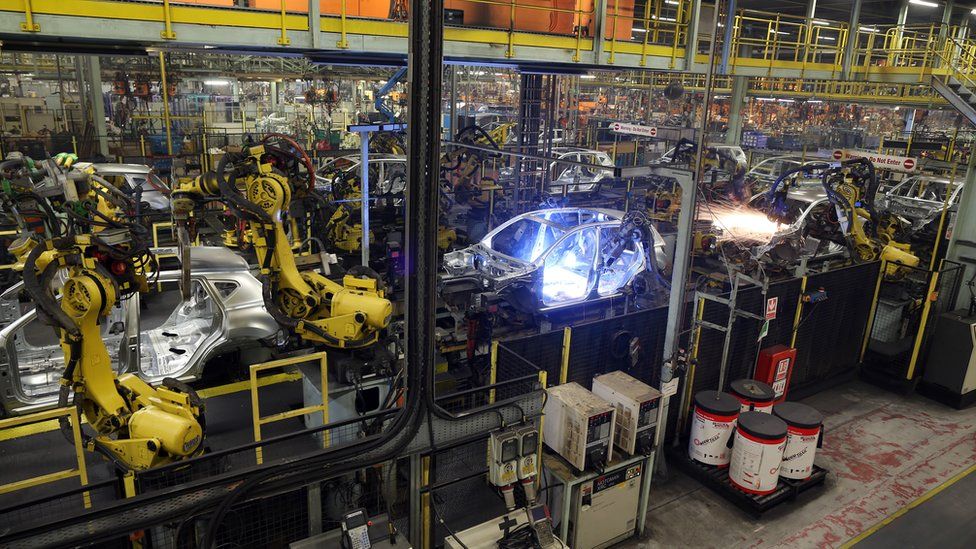 Robotic arms assemble and weld the body shell of a Nissan car on the production line at Nissan's Sunderland plant