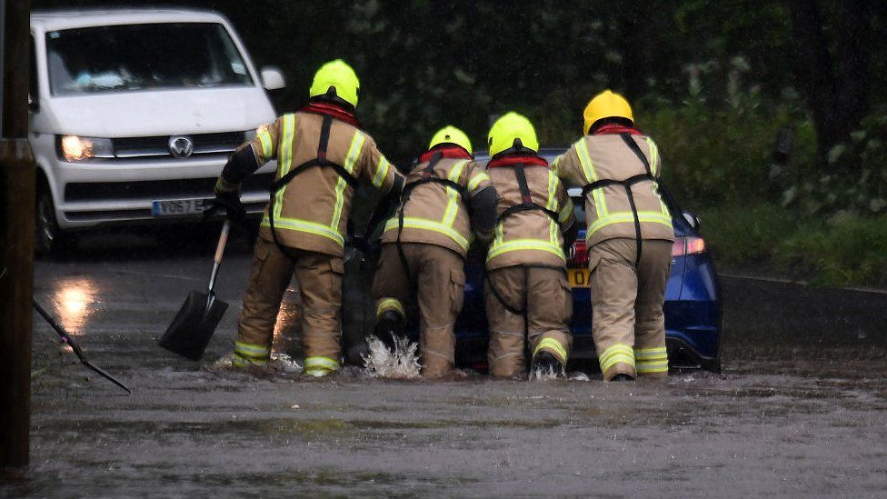 Fire crews help a car out of flood water in Lochwinnoch