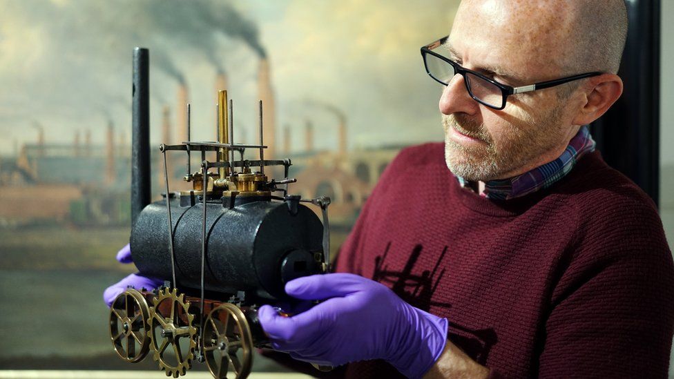 John McGoldrick, curator of industrial history, with the model