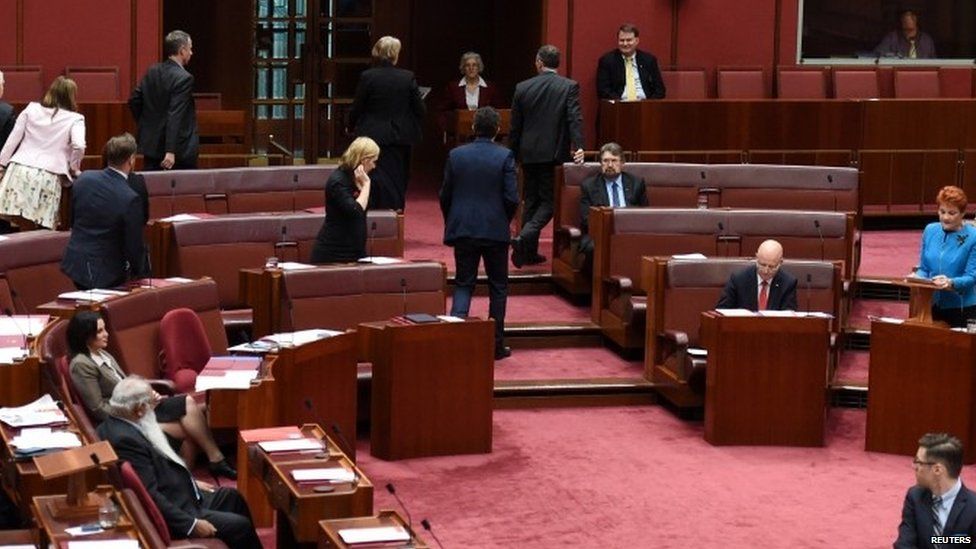 Green Party senators walk out as Australia's One Nation party leader Pauline Hanson (right) makes her maiden speech