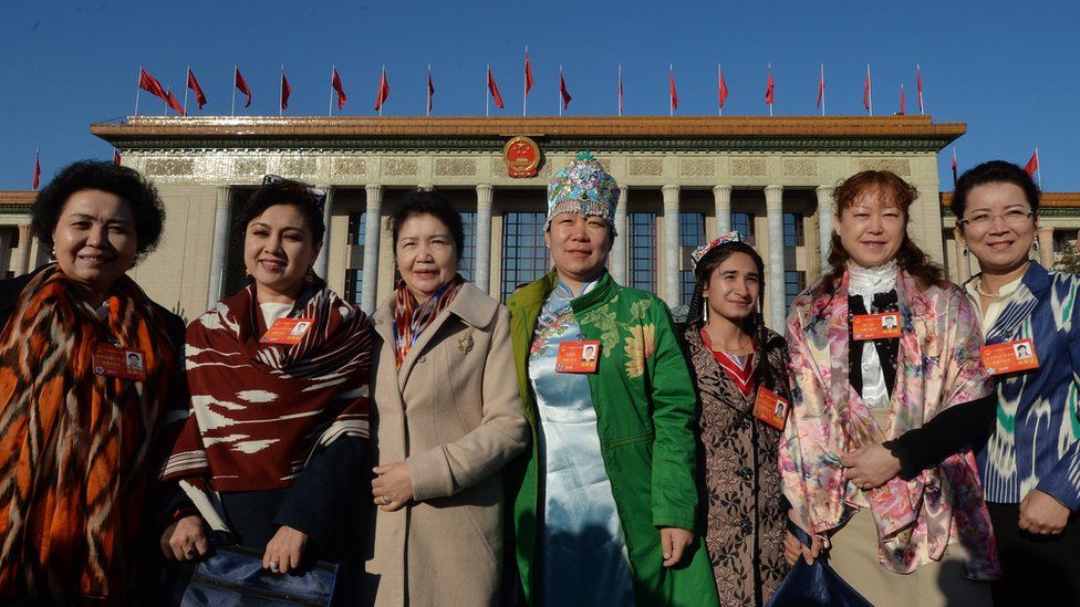 Chinese Uighur delegates from Xinjiang province arrive for the first session of the National People's Congress at the Great Hall of the People in Beijing on March 5, 2014.